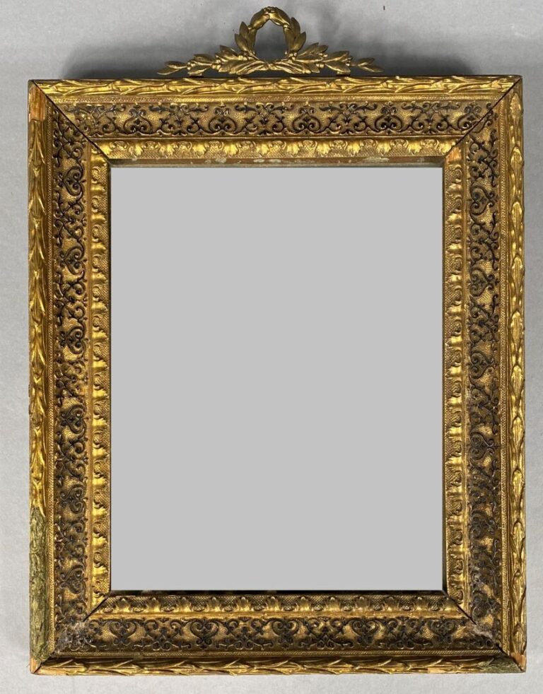 Petit miroir rectangulaire en bois et stuc doré à décor de frises et surmonté d…