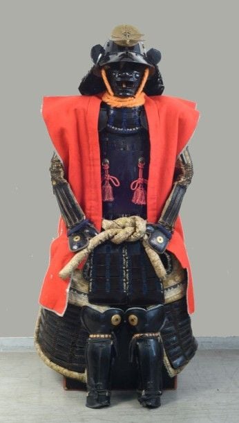 ARMURE DE SAMOURAI - YOROI Japon, Période Edo Armure de combat japonaise aux armoiries du clan Kato (Snake Eye Mon) y compris sur le Jinbaori, entièrement en fer en Itamono et tressage Sugake bleu: > Le casque de type Sujibachi à huit plaques > Le Maedate (ornement du casque) en bois doré représentant une libellule sur la rondelle du "Snake Eye Mon" > Le Menpo laqué noir comme le Yodarekake composé de cinq lamelles