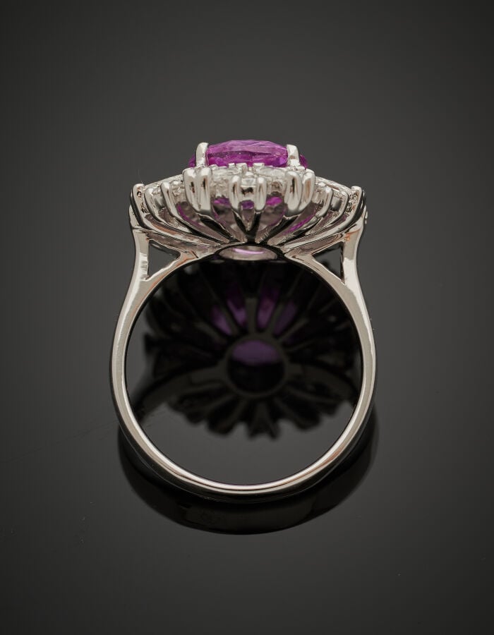 BAGUE en or gris (750‰) serti d'un saphir rose ovale pesant 3,17 carats, entour…