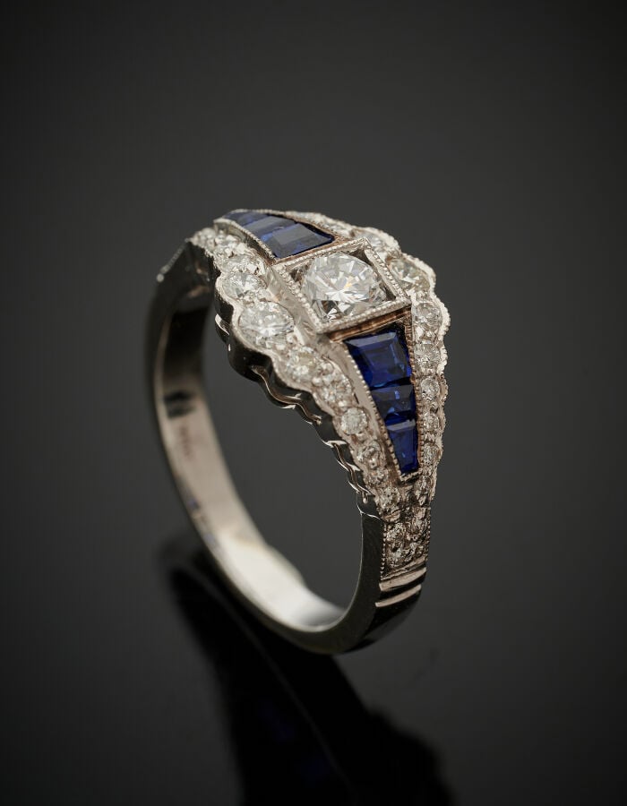 BAGUE en or gris (750‰) serti de diamants taille brillant dont un au centre plu…