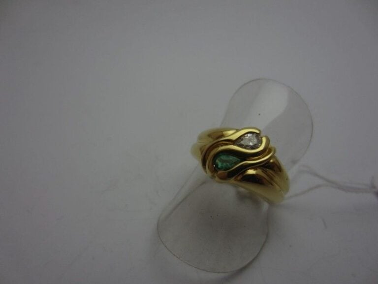BAGUE en or jaune (750 millièmes) godronné serti d'une émeraude et d'un diamants de forme poir