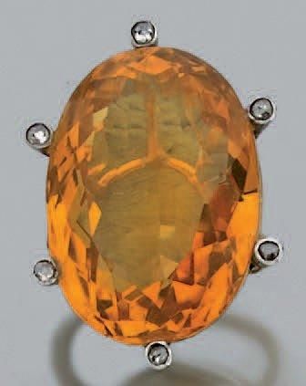 BAGUE en or jaune serti d'une importante citrine de forme ovale entourée de diamants taillés en ros
