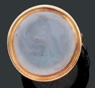 BAGUE en or jaune serti d'une intaille en agate blanche à motif de personnage pensant, de forme circulair