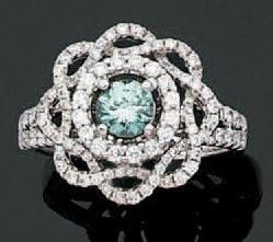 BAGUE «fleur» en or gris ajouré serti d'un diamant bleu (couleur traitée) taille brillant entouré de petits diamant