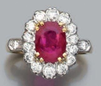 BAGUE «marguerite» en or jaune et or gris serti d'un rubis ovale entouré de diamants taille brillan