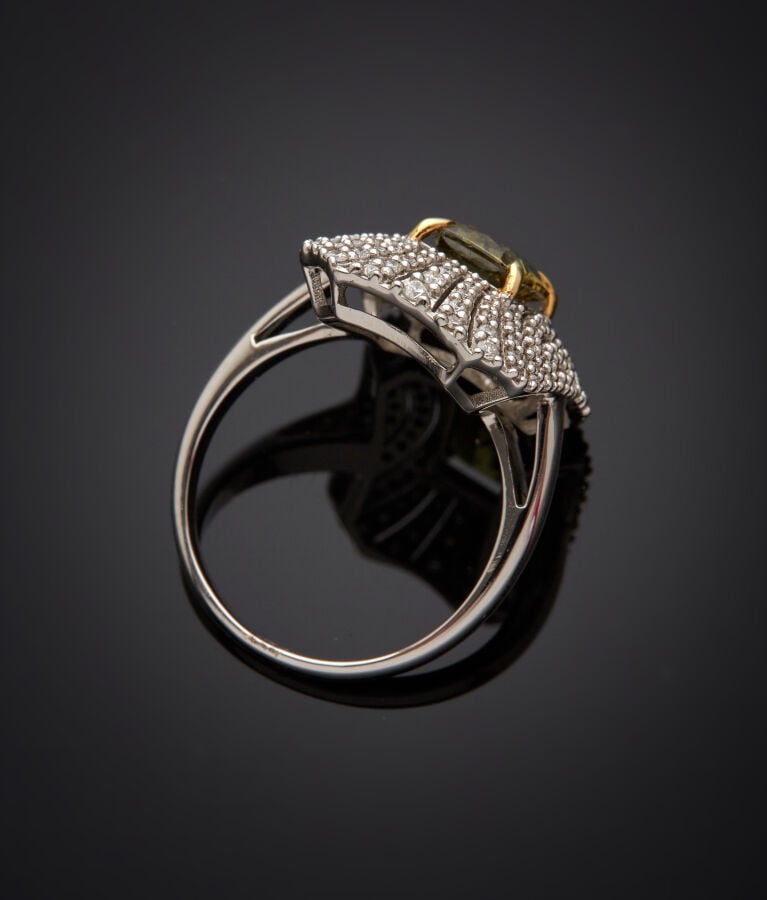 BAGUE octogonale en or gris (750‰) ajouré, serti d'un grenat démantoïde pesant…