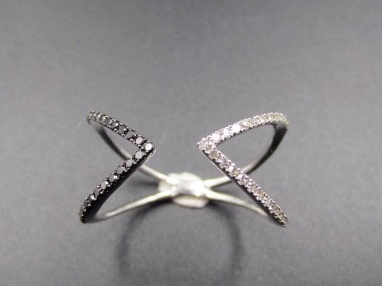 BAGUE ouverte « triangles » en or gris et or noirci (750 millièmes) ajouré, serti d’alignements de diamants taille 8      8, noirs et blancs        Doigt : 53        Poids brut : 1,7 g