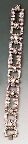Bracelet articulé à motifs géométriques en platine ajouré, serti de diamants ronds dont trois plus important