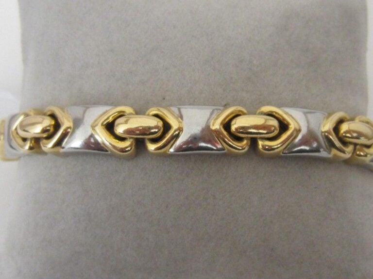 BRACELET articulé en or jaune (750 millièmes) et acier à maillons géométrique