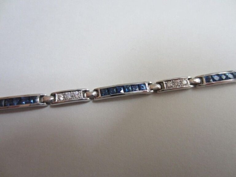 BRACELET en or gris (750 millièmes) serti de diamants et saphirs calibrés alterné