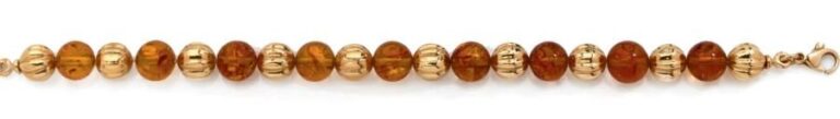 BRACELET en or jaune (750 millièmes) composé de boules godronnée alternées de perles d'ambr