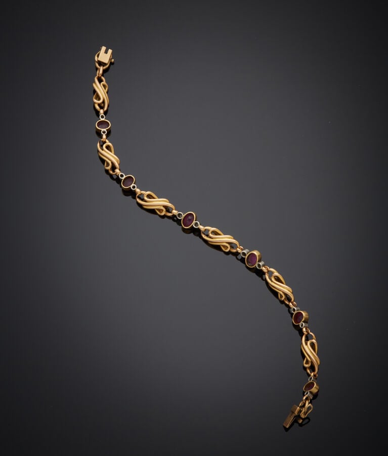 BRACELET en platine (min. 800‰) et or jaune (750‰) à motif de volutes, serti de…