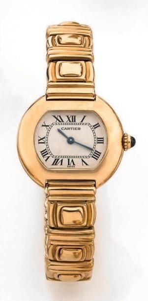 BRACELET MONTRE de dame en or jaune (750 millièmes), de forme «tonneau