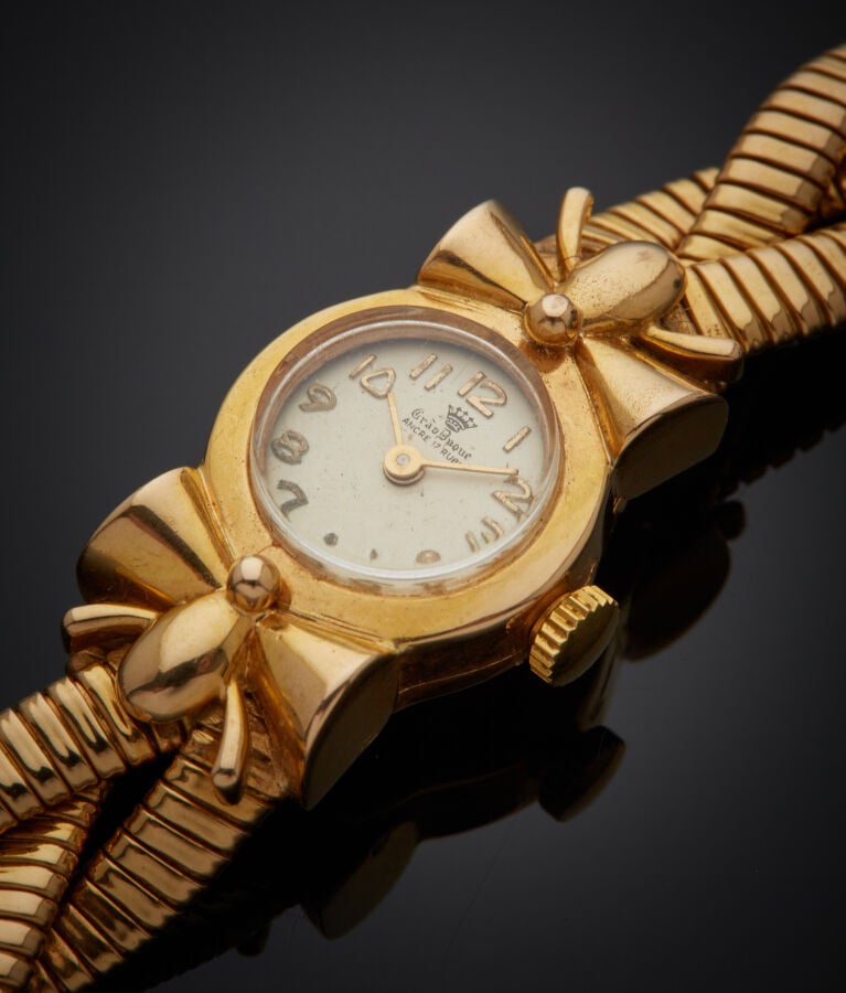 BRACELET MONTRE ronde de dame en or jaune, attaches "noeuds". Bracelet tressé à…