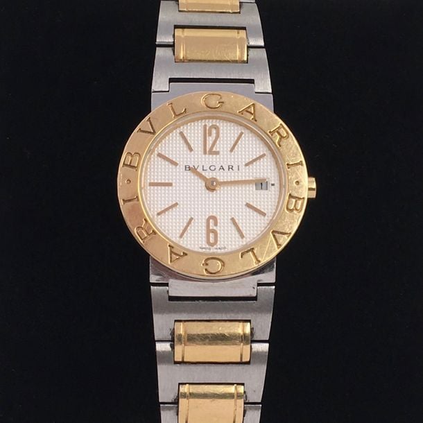 BRACELET MONTRE ronde en or jaune (750 millièmes) et acie