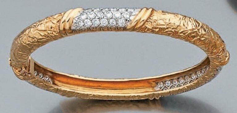 BRACELET rigide ouvrant en platine et or jaune ciselé partiellement serti de pavages bombés de diamant