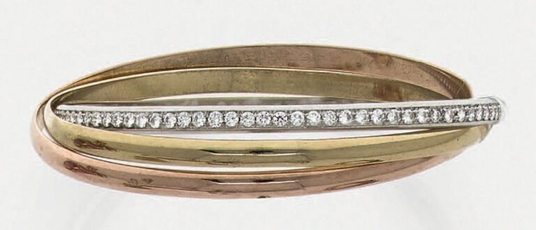 BRACELET «Trinity» trois anneaux, trois ors (750 millièmes) dont un serti d'un alignement de diamants taille brillan