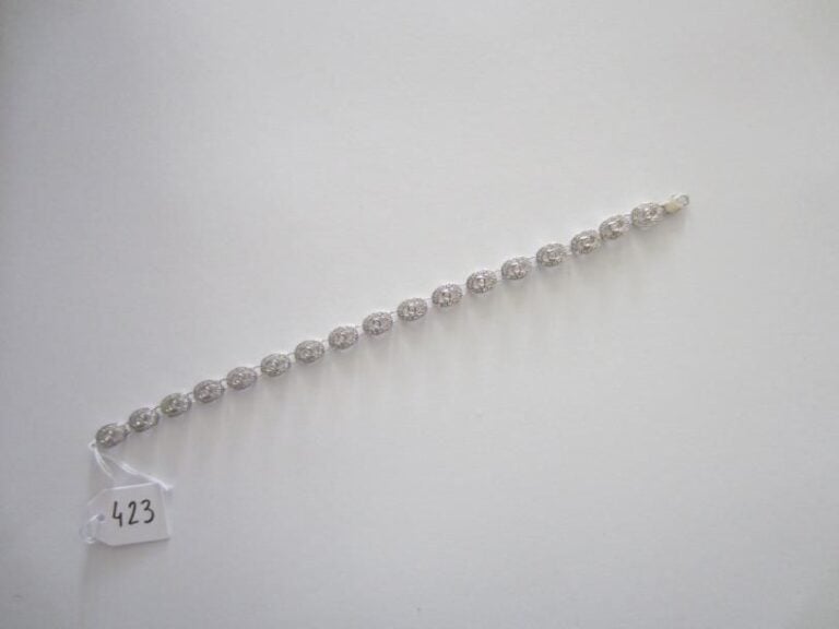 BRACELET «volutes» en or gris articulé et ajouré serti de diamant