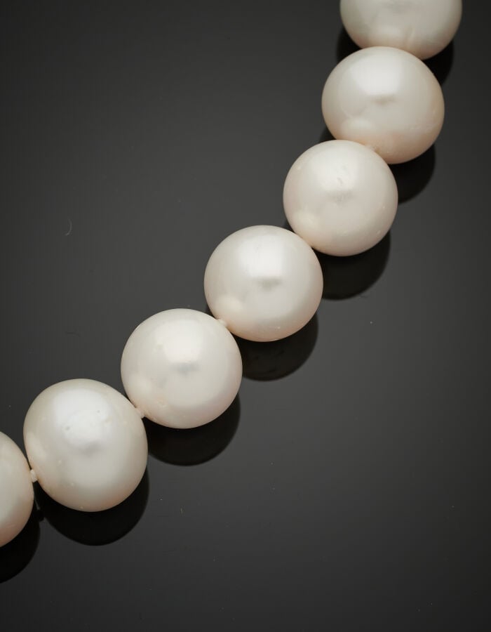 COLLIER composé d'un rang de 32 perles de culture blanches. Fermoir boule en or…