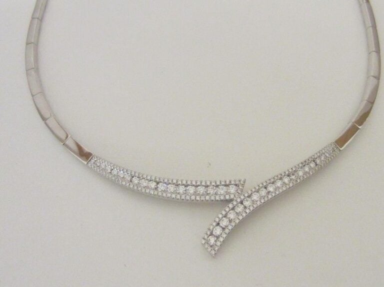 COLLIER en or gris (750 millièmes) partiellement articulé et serti de trois lignes de diamants taille brillant dont une, au centre, plus important