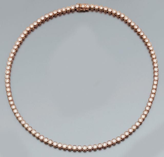 COLLIER en or rose articulé composé d'un alignement de diamants taille brillant en serti clo