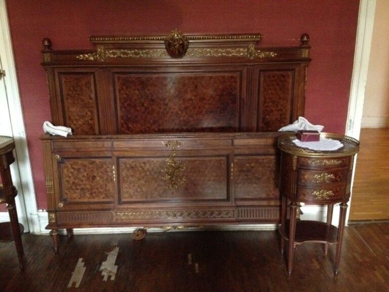 D'UN ENSEMBLE DE CHAMBRE A COUCHER DE STYLE LOUIS XVI en bois de placage à garniture de bronzes dorés ciselés comprenant un lit, une armoire, deux chevets, une commode, un bureau / secrétaire à abattant