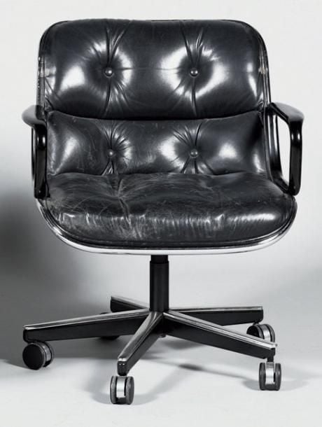 Fauteuil de bureau à coque formant dossier galbé et accotoirs pleins gainés de cuir sur piétement central à cinq pieds sur roulette (usures