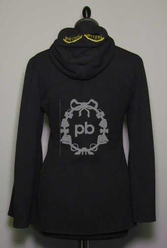 Femme (automne-hiver 1991/92, collection "French cancan") VESTE cintrée zippée en crêpe jersey de laine noir, capuche agrémentée d'un 'loup' rebrodé de petites perles jaune, manches pagode, deux poches verticales (griffe noire, graphisme vert) (T42 it) (mini manque sur loup) Bibliographie: veste similaire pour Homme reproduite