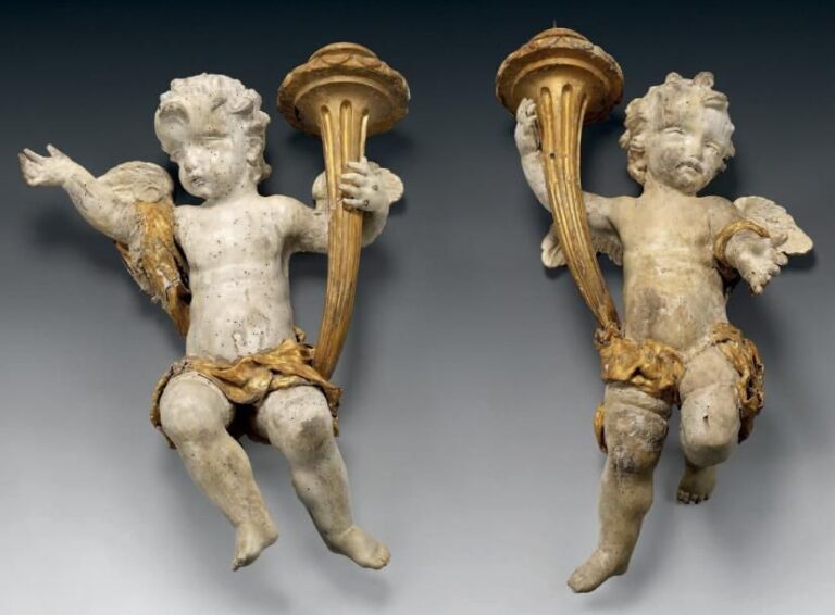 Grande paire d'angelots en tilleul sculpté, laqué ou doré, ils sont représentés tenant du bras droit un flambeau à cannelures rudentées et portant des drapés en toile enduite et doré