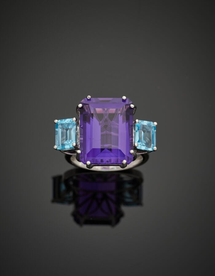 Importante BAGUE en or gris (750‰) serti d'une améthyste, épaulée de deux topaz…