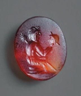 Intaille ovale gravée d'un personnage assis tenant un thyrse (?) et regardant un masque de théâtr