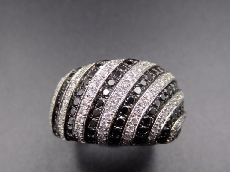 Large BAGUE en or gris et or noirci (750 millièmes) partiellement serti de lignes alternées de diamants noirs et blancs             Doigt : 54-55        Poids brut : 8,9 g
