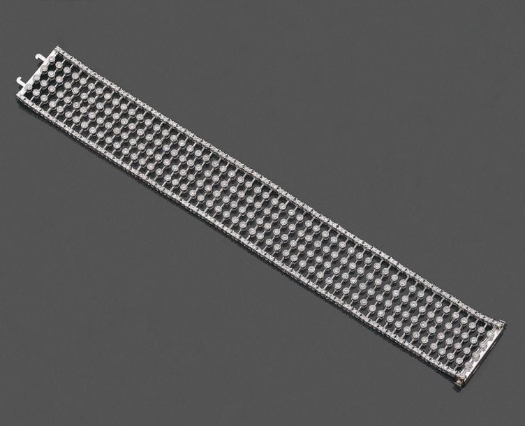 •Large BRACELET «manchette» en or gris (750‰) ajouré, serti de diamants taille brillan