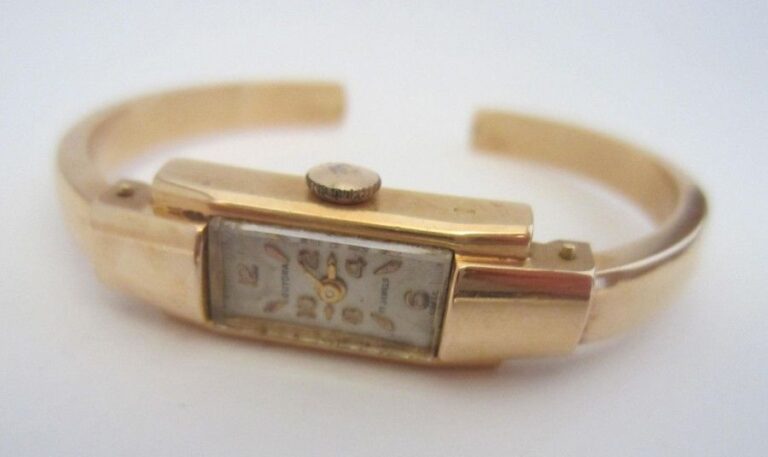 Montre de dame de marque Guyora, à braceletjonc ouvert en or jaune (750 millièmes
