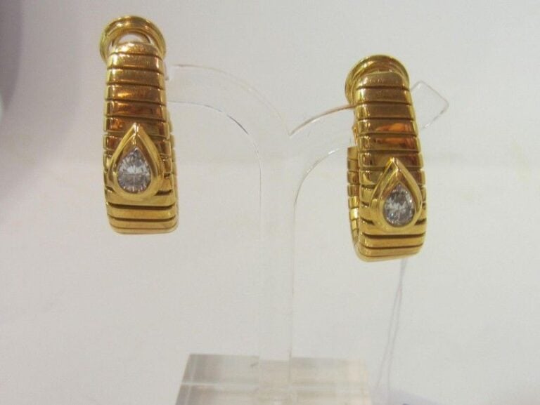 PAIRE DE BOUCLES D’OREILLES «créoles» en or jaune (750 millièmes) à godrons plats, surmonté d’un diamant taille poir