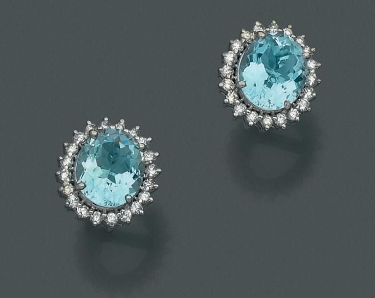 PAIRE de BOUCLES D’OREILLES en or gris (750 millièmes) serti d’une aigue-marine de forme ovale entourée de diamants taille brillan