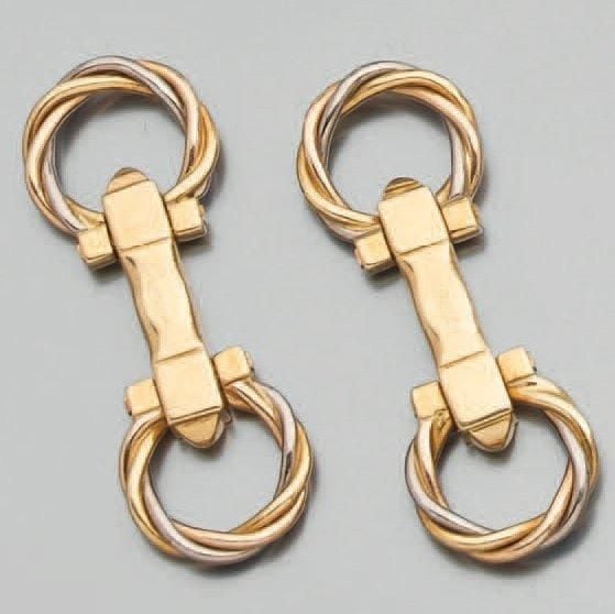Paire de BOUTONS DE MANCHETTES en or jaune et or gris torsadé et articulés, à motifs circulaire