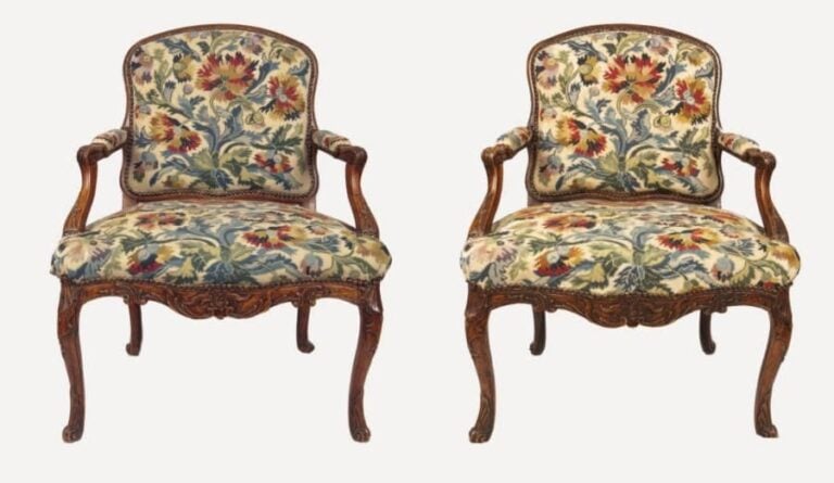 Paire de fauteuils à dossier plat, en hêtre mouluré et sculpté de lambrequins et feuilles d'acanth