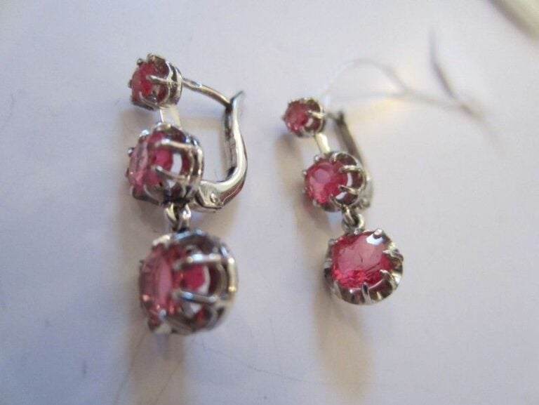 PAIRE DE PENDANTS D'OREILLES "dormeuse" en platine serti d'un alignement de trois spinelles rose