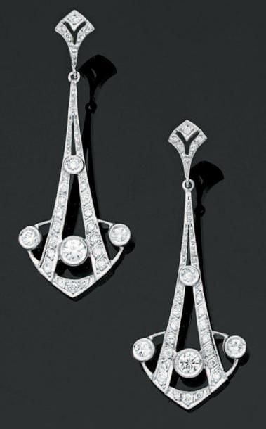 PAIRE de PENDANTS D'OREILLES géométriques en or gris ajouré serti de diamants taille brillant, dont un plus importan