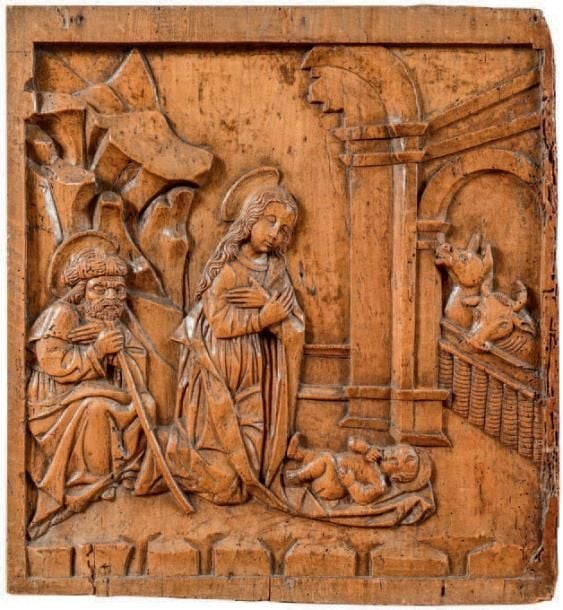 Panneau en tilleul sculpté au thème de la Nativité; la Vierge et Joseph agenouillés contemplant l'Enfant