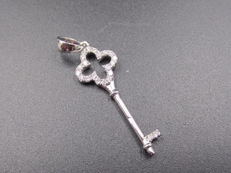 PENDENTIF « clé » en or gris « 750 millièmes) ajouré partiellement serti de diamants taille brillan