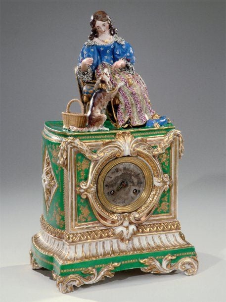 Pendule borne, en porcelaine à fond vert à décor doré d'un semis de fleur