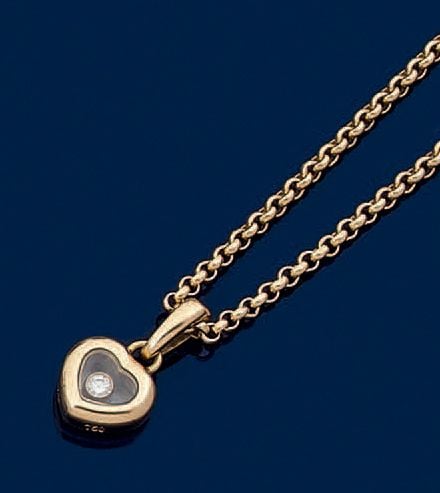 Petit PENDENTIF «coeur», et sa chaînette, en or jaune (750 millièmes) renfermant un petit diamant taille brillant sous verr