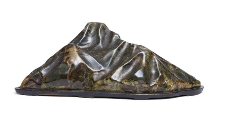 Pierre-paysage suiseki polie de couleur noirâtre, verte et marron figurant une montagne escarpé