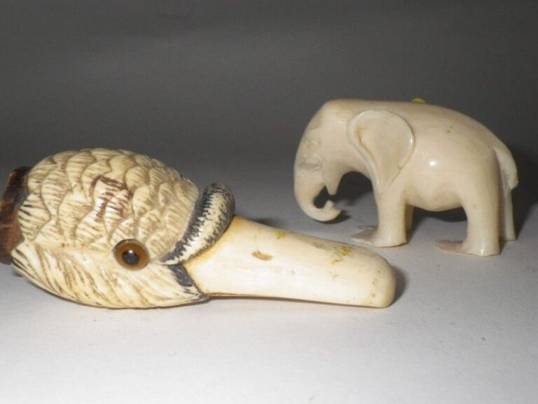 Pommeau d'ombrelle en ivoire sculpté; on y joint un petit éléphant en ivoir