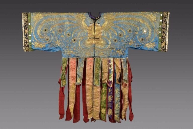 PROBABLE ROBE / SURTOUT DE PETITE FILLE HAN OU COSTUME DE THEATRE EN SOIE BRODEE Chine, Fin de la Dynastie Qing, Vers 1900 A col rond et ouverture au devant, dans l'axe, maintenue par plusieurs boutons, métalliques et de tiss