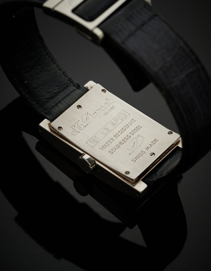 S.T. DUPONT - BRACELET MONTRE rectangulaire en acier. Cadran bleu nuit, guichet…