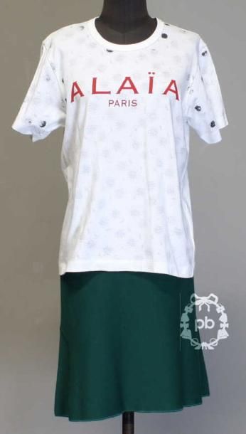 T-SHIRT en jersey de coton blanc imprimé d'un motif floral noir sur l'envers et figurant la griffe rouge sur le devant (TM