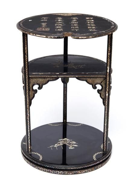 Table basse noire de forme ronde, avec deux plateau